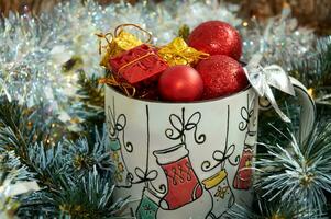 Christmas background with beautiful mug with gifts and balls in beautiful tinsel photo