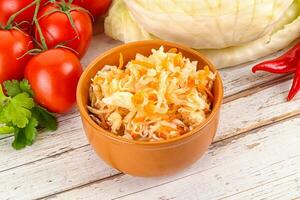 Fermented cabbage sauerkraut in the bowl photo