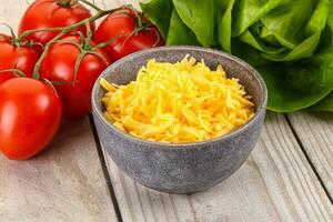 Shredded cheese in the bowl photo