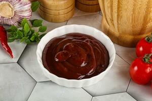 Tasty barbecue sauce in the bowl photo