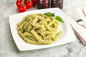 Italian pasta with basil pesto photo
