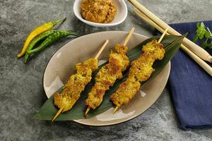 Thai meat skewer Satay with sauce photo