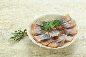 Delicous sliced herring fillet in grape sauce photo