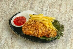 Crispy chicken leg with fry potato photo