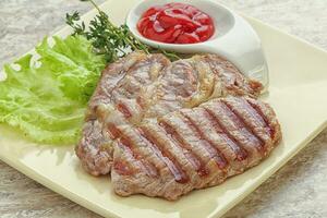 Grilled pork neck steak with ketchup photo