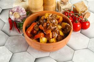 Homemade beef hungarian goulash with potato photo