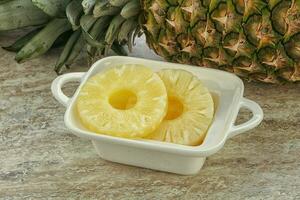 Marinated pineapple rings in the bowl photo