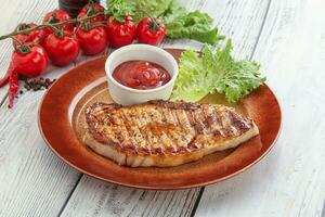 Grilled pork steak with ketchup photo