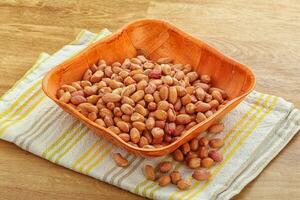 Raw peanut heap in the bowl photo