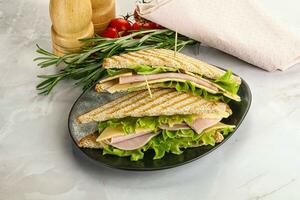 Homemade club sandwich with ham and cheese photo