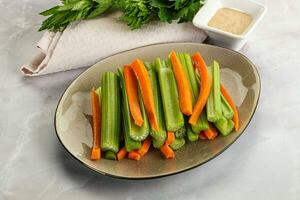 Vegan cuisine - dietary celery and carrot cticks photo