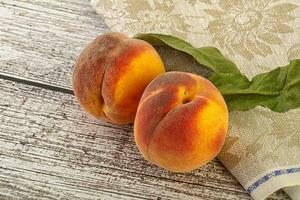 Two ripe sweet peaches fruit photo