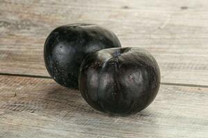 Two ripe sweet black plums photo