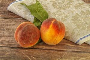 Two ripe sweet peaches fruit photo