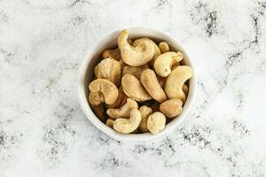 Cashew nuts heap in the bowl photo