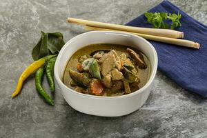 Thai green curry soup with basil photo