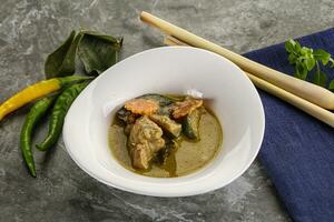 Thai green curry soup with basil photo
