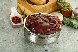 Raw uncooked chicken liver in the bowl photo