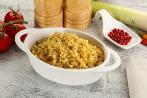 Boiled bulgur wheat in the bowl photo