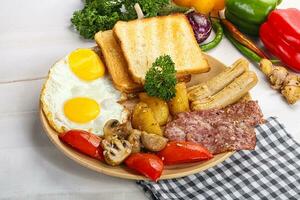 English breakfast with toast, egg and sausages photo