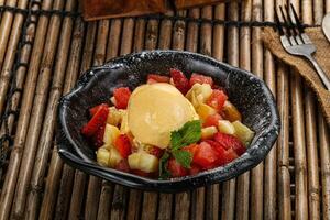 Sweet fruit salad with ice cream photo