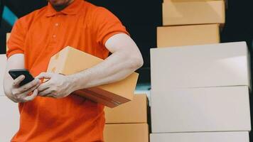 Fast and reliable service. Cheerful young delivery man giving a cardboard box to young woman while standing at the entrance of her apartment video