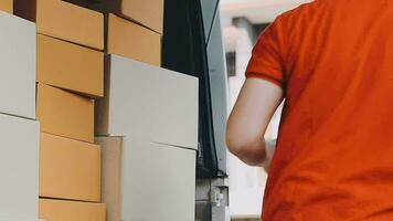 Fast and reliable service. Cheerful young delivery man giving a cardboard box to young woman while standing at the entrance of her apartment video