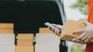 Fast and reliable service. Cheerful young delivery man giving a cardboard box to young woman while standing at the entrance of her apartment video