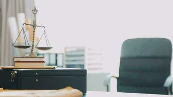 Business and lawyers discussing contract papers with brass scale on desk in office. Law, legal services, advice, justice and law concept picture with film grain effect video