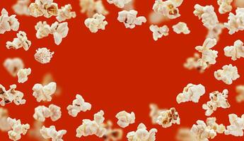 Popcorn frame, flying popcorn isolated on red background with copy space, movie poster concept photo