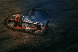 Love New York Concept. Reflection of Big Bridge Through Puddle in Shape of Heart. 3d Rendering photo