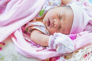 Cute little baby sleeping on bed at home. photo