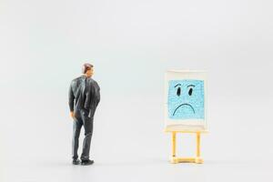 Miniature people, A dejected businessman is positioned in front of a white board, Blue monday concept photo