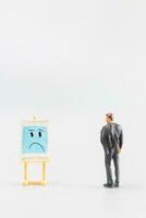 Miniature people, A dejected businessman is positioned in front of a white board, Blue monday concept photo