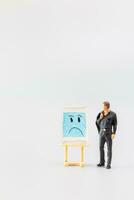 Miniature people, A dejected businessman is positioned in front of a white board, Blue monday concept photo