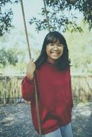 asian teenager toothy smiling with happiness in park photo