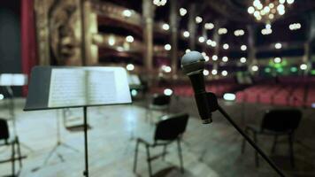 An empty stage with a microphone and chairs video