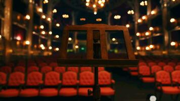 An empty auditorium with red seats and lights video