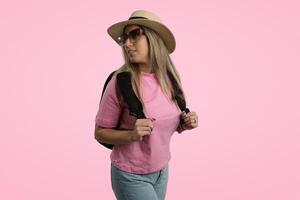 Happy Person in Fashionable Clothing Standing in a Pink Studio photo