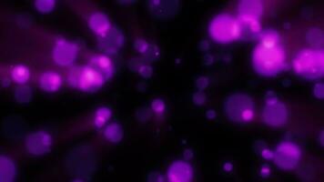 Abstract purple blurred holiday background with magical bokeh of glowing bright light energy small particles of flying dots on a black background video