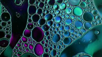 Abstract Colorful Food Oil Drops Bubbles and spheres Flowing on Water Surface photo