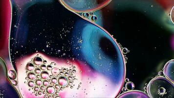 Abstract Colorful Food Oil Drops Bubbles and spheres Flowing on Water Surface photo