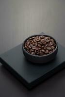 Roasted coffee beans on a black digital scale. photo