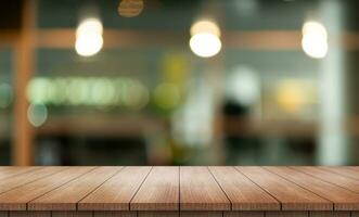 Empty wooden table top with lights bokeh on blur restaurant background. photo