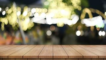 Empty wooden table top with lights bokeh on blur restaurant background. photo