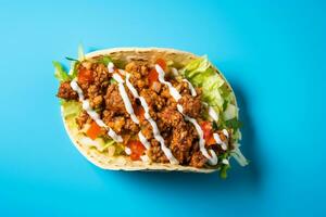 tacos with meat and vegetables on a blue background photo