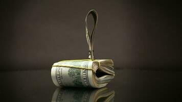 stack of dollar bills collected in an elastic band and a stationery clip video