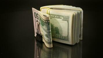 stack of dollar bills collected in an elastic band and a stationery clip video