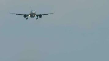 Bottom view, jet passenger plane with glowing headlights approaching landing video