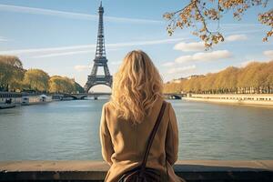 AI generated Young woman looking at Eiffel Tower in Paris, France, Young traveler woman rear view sitting on the quay of Seine River looking at Eiffel Tower, AI Generated photo